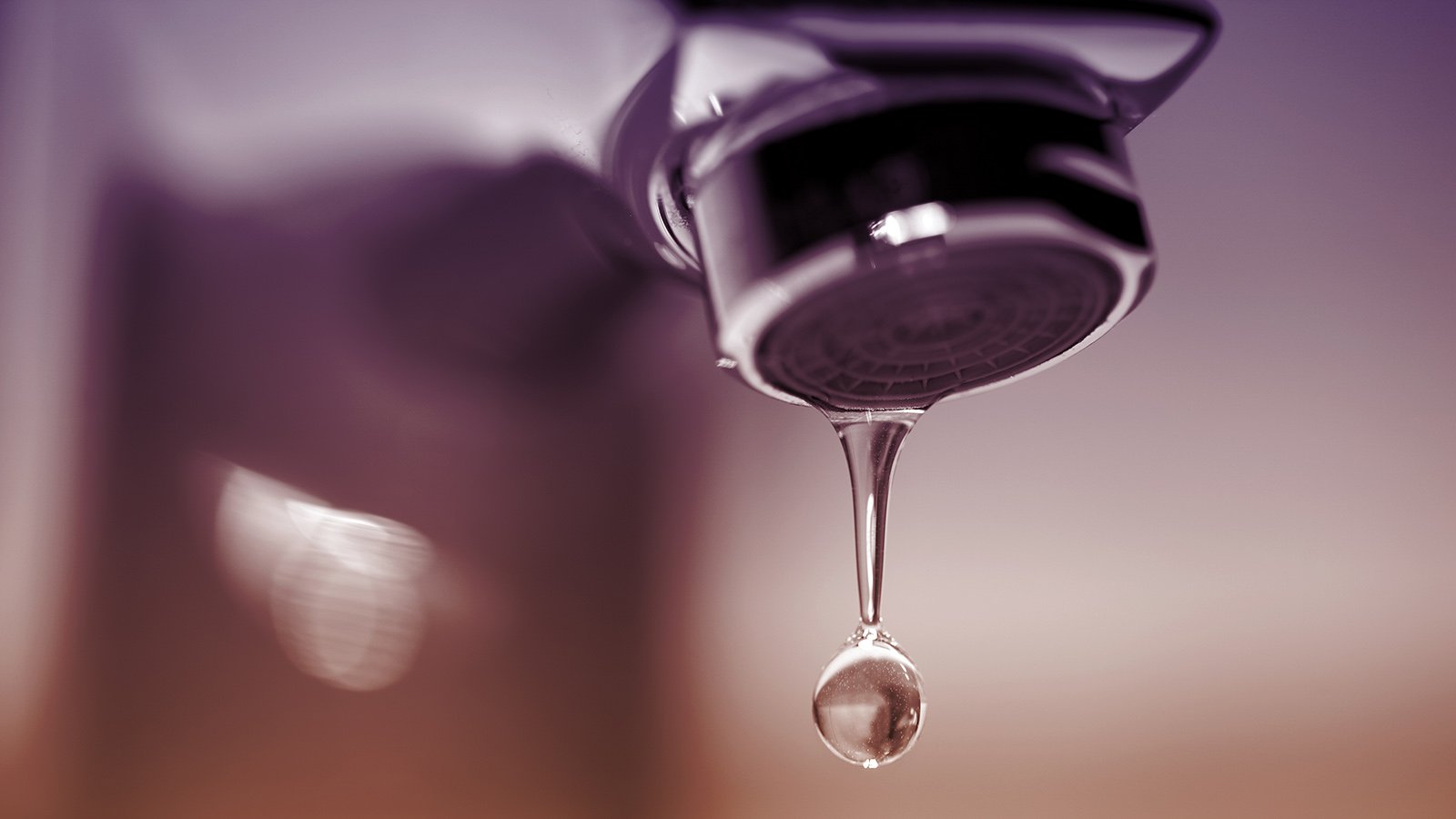 Dripping Faucet Close-up with Drop of Water